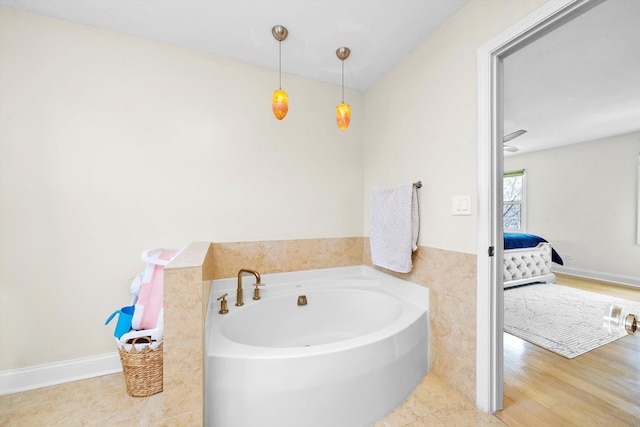 ensuite bathroom with connected bathroom and a bath