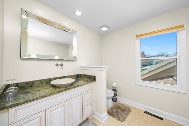 bathroom with baseboards, toilet, visible vents, tile patterned floors, and vanity