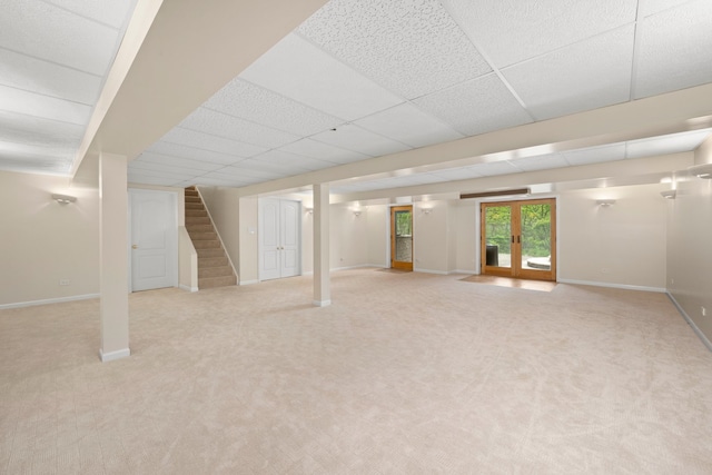 717 Stonebridge Rd, Frankfort, IL 60423 - below grade area with stairs, light colored carpet, baseboards, french doors, and a drop ceiling