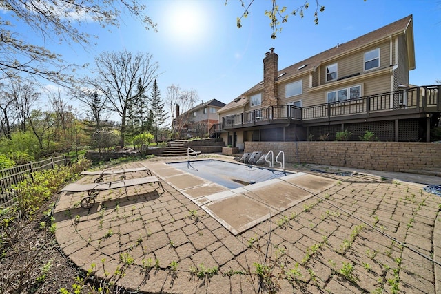 view of pool with a patio, a deck, fence, and a fenced in pool