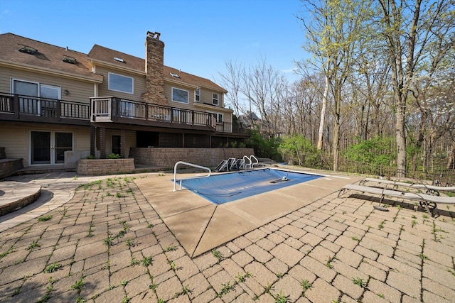 view of pool featuring a wooden deck, a patio, and a fenced in pool