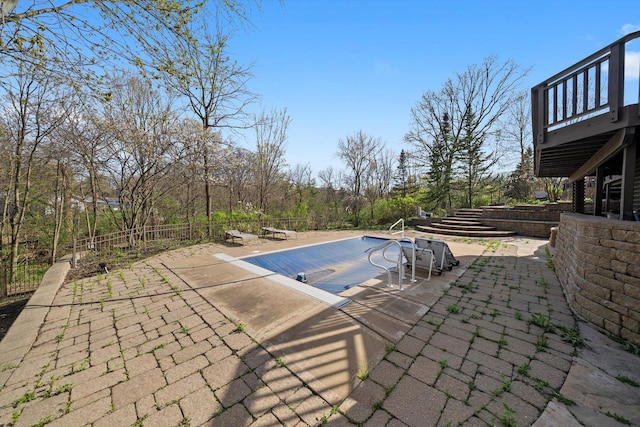 view of pool featuring a patio area, a fenced in pool, and fence