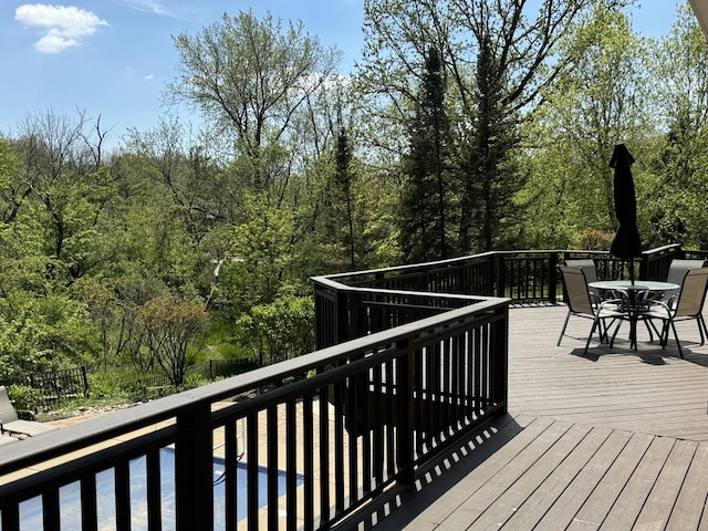 717 Stonebridge Rd, Frankfort, IL 60423 - wooden deck featuring outdoor dining space, fence, and a wooded view