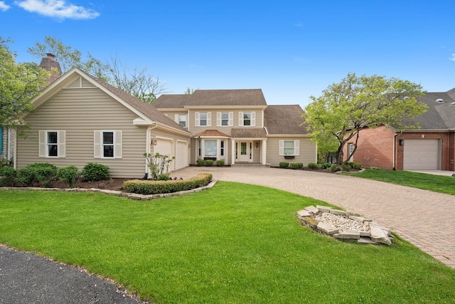 717 Stonebridge Rd, Frankfort, IL 60423 - view of front of house with an attached garage, driveway, a front yard, and a chimney