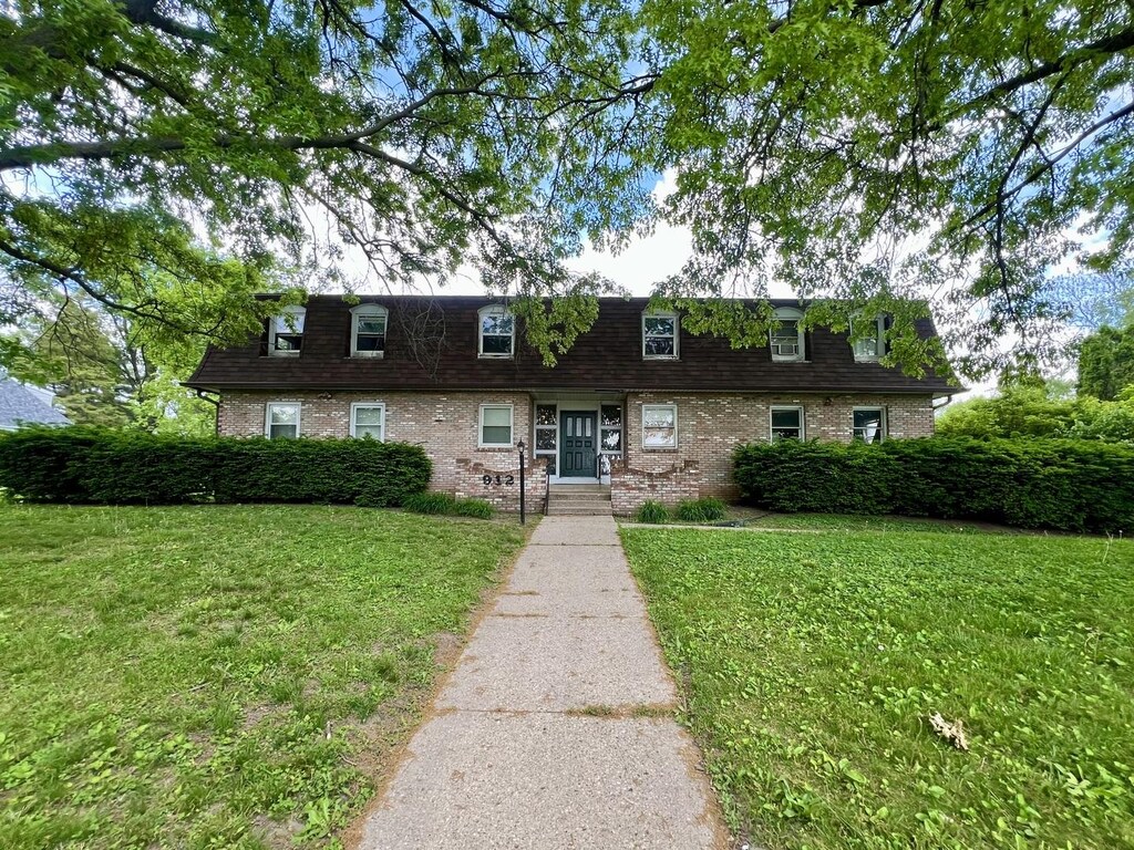 912 Crescent Dr Unit 2-4, Champaign, IL 61821 - view of front of property featuring a front lawn, brick siding, and mansard roof