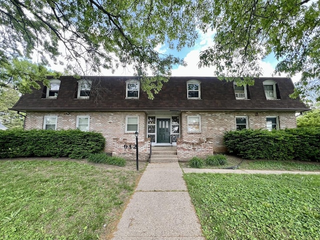 912 Crescent Dr Unit 2-4, Champaign, IL 61821 - view of front facade with mansard roof, brick siding, and roof with shingles
