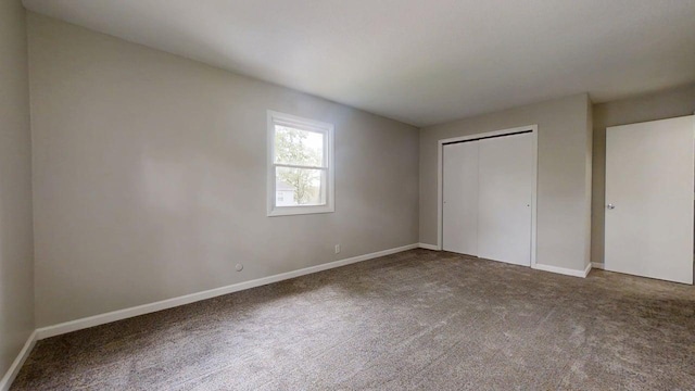 912 Crescent Dr Unit 2-4, Champaign, IL 61821 - unfurnished bedroom featuring carpet flooring, baseboards, and a closet