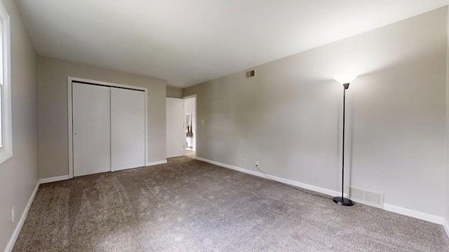 912 Crescent Dr Unit 2-4, Champaign, IL 61821 - unfurnished bedroom with carpet floors, a closet, and baseboards