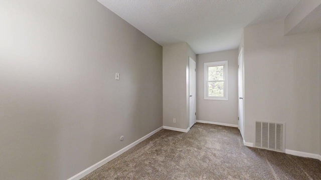 912 Crescent Dr Unit 2-4, Champaign, IL 61821 - spare room with carpet, baseboards, and a textured ceiling