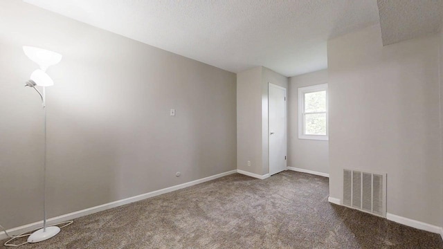 912 Crescent Dr Unit 2-4, Champaign, IL 61821 - carpeted spare room featuring baseboards and a textured ceiling