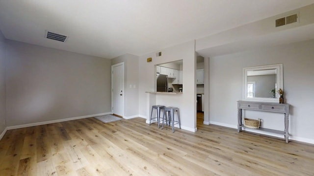 912 Crescent Dr Unit 2-4, Champaign, IL 61821 - unfurnished living room featuring light wood-type flooring and baseboards