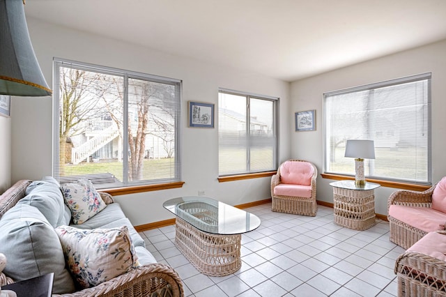 living room with light tile patterned floors and baseboards