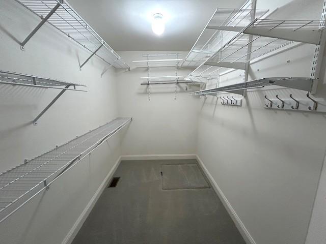 spacious closet featuring visible vents
