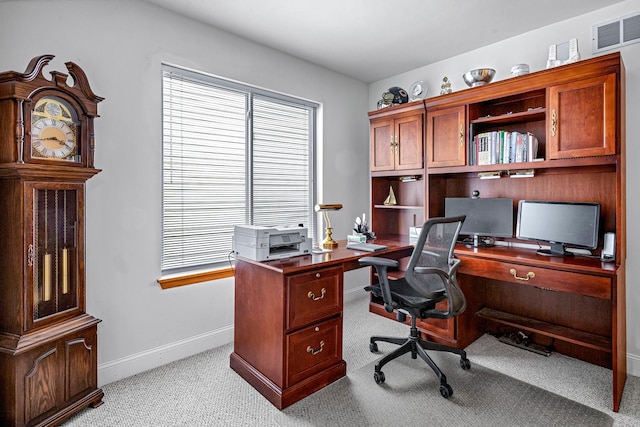 office featuring visible vents, baseboards, and light colored carpet