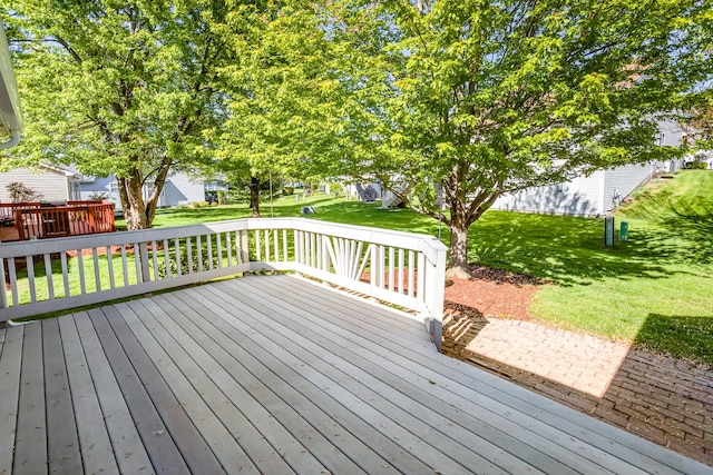 wooden terrace with a yard