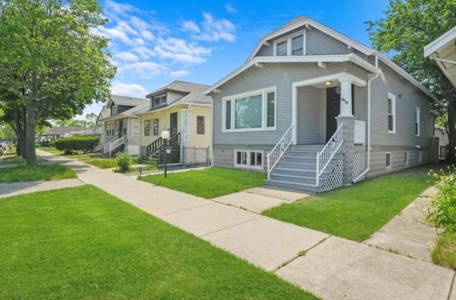 9912 S Yale Ave, Chicago, IL 60628 - bungalow-style home featuring covered porch, a front lawn, and stairs
