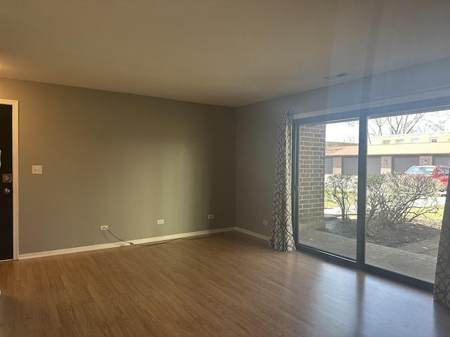 217 Uteg St Unit A, Crystal Lake, IL 60014 - unfurnished room featuring visible vents, baseboards, and wood finished floors