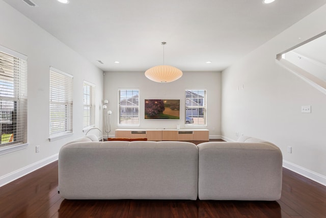 living room with recessed lighting, dark wood-style flooring, and baseboards