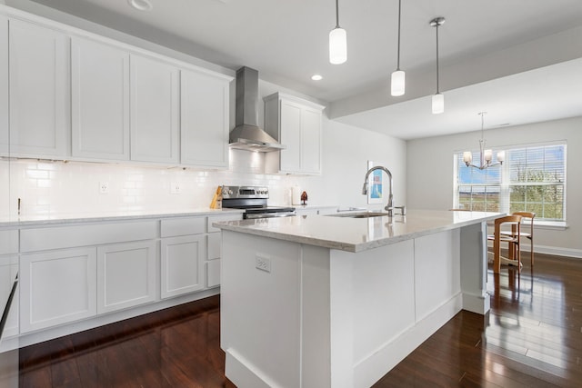 kitchen featuring wall chimney exhaust hood, a sink, a chandelier, dark wood-style floors, and electric range
