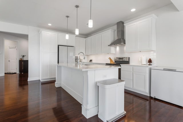 kitchen featuring white fridge, wall chimney exhaust hood, a sink, recessed lighting, and electric range