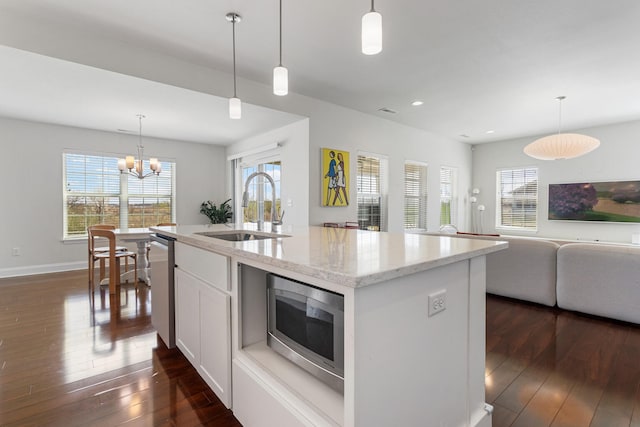 kitchen featuring recessed lighting, open floor plan, dark wood-style floors, stainless steel appliances, and a sink
