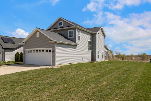 view of side of home featuring a yard, driveway, and a garage
