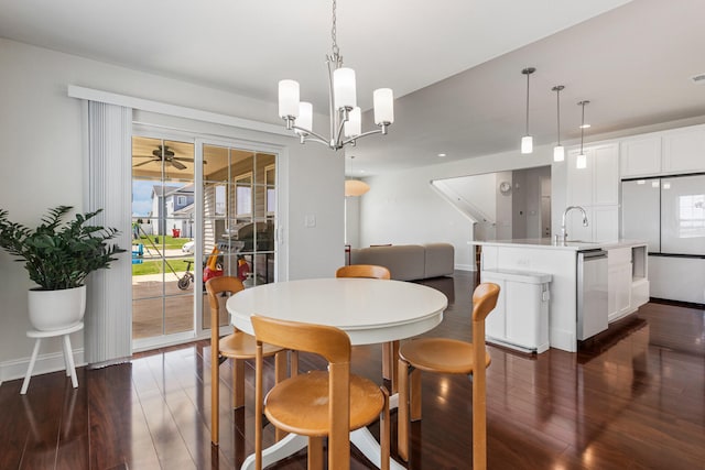 dining space with recessed lighting, dark wood-style flooring, baseboards, and an inviting chandelier