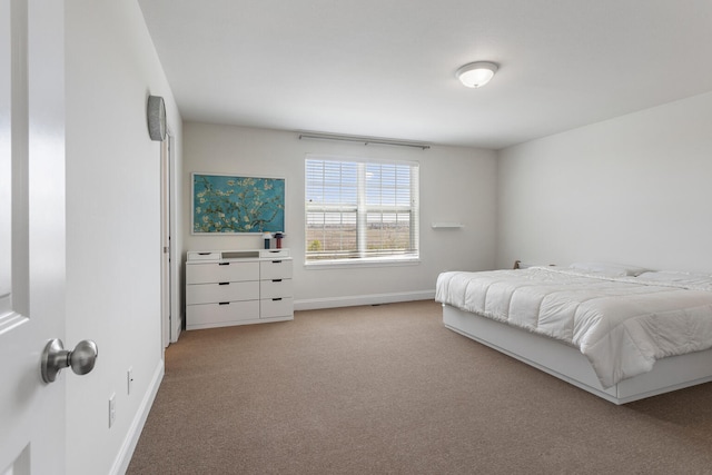 bedroom with baseboards and carpet
