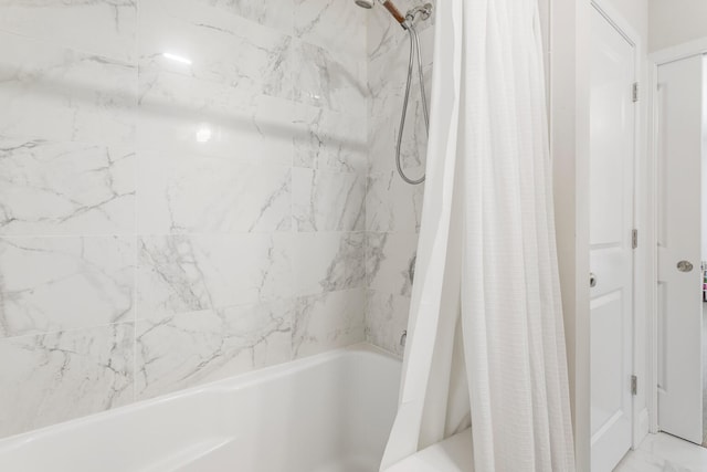 full bath with marble finish floor and shower / bath combo with shower curtain