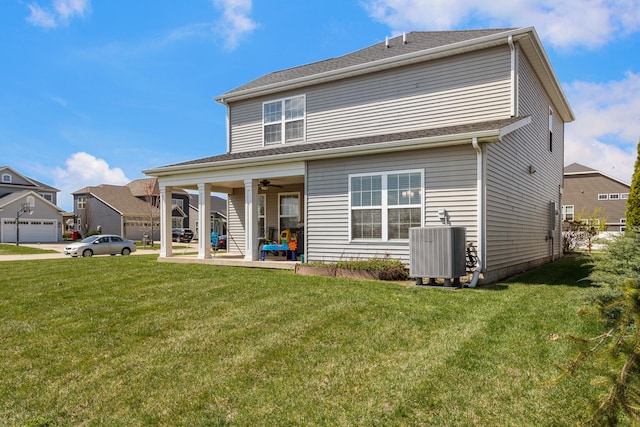 rear view of house featuring central air condition unit, a yard, a patio area, and a ceiling fan