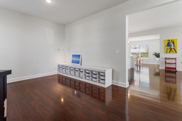 spare room featuring wood-type flooring, baseboards, recessed lighting, and a chandelier
