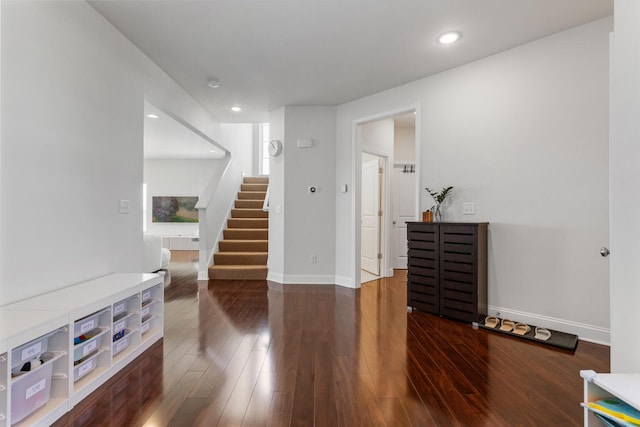 interior space featuring wood finished floors, recessed lighting, baseboards, and stairs