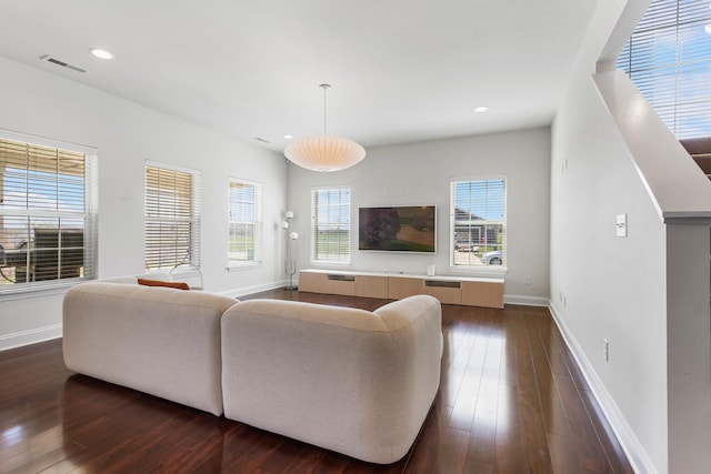 living room with visible vents, baseboards, recessed lighting, and dark wood finished floors