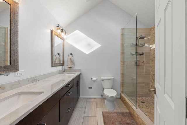 full bathroom featuring a shower stall, vaulted ceiling, toilet, a sink, and double vanity