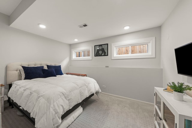carpeted bedroom featuring baseboards, visible vents, and recessed lighting