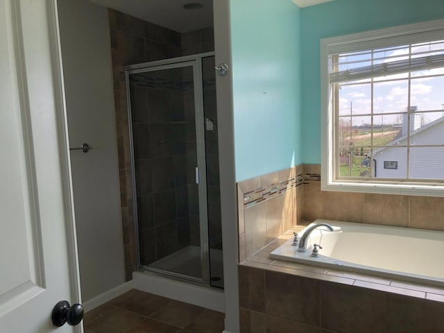 bathroom with tile patterned floors, a garden tub, and a shower stall