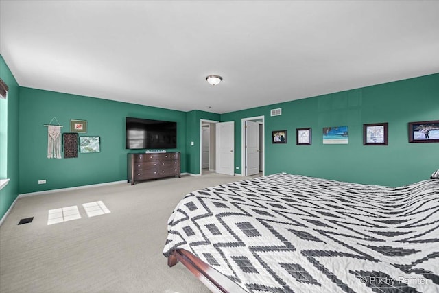 carpeted bedroom featuring visible vents