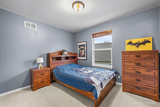 bedroom featuring baseboards, visible vents, and light carpet