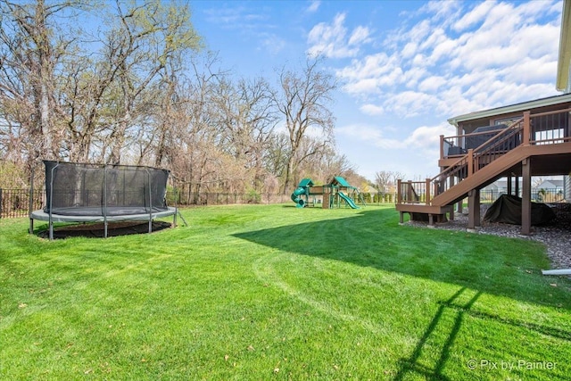 view of yard featuring a playground, a trampoline, stairway, and a fenced backyard