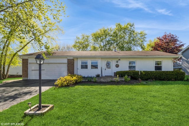 single story home with an attached garage, asphalt driveway, and a front lawn