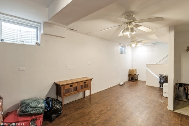 below grade area with wood finished floors and a ceiling fan