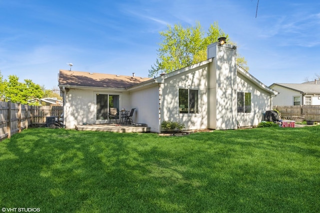 rear view of house with a chimney and a patio area