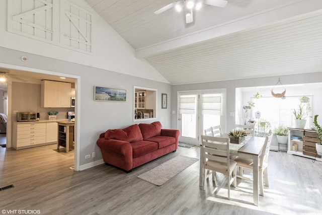 dining area with a ceiling fan, light wood-style floors, and baseboards