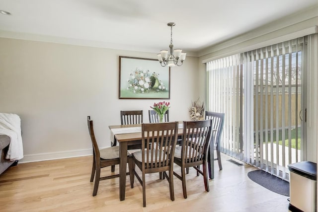 5740 Alabama Ave, Clarendon Hills, IL 60514 - dining area with light wood finished floors, baseboards, a chandelier, and visible vents