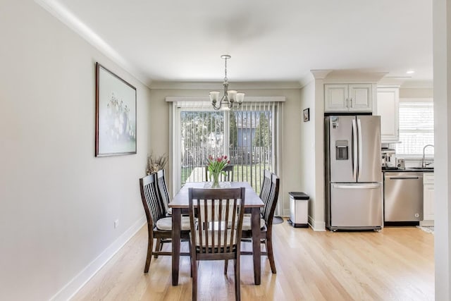 5740 Alabama Ave, Clarendon Hills, IL 60514 - dining space featuring baseboards, crown molding, a chandelier, and light wood-type flooring