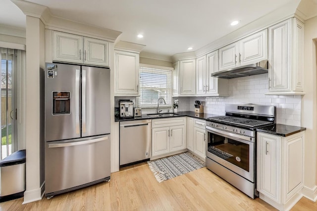 5740 Alabama Ave, Clarendon Hills, IL 60514 - kitchen with under cabinet range hood, dark countertops, a sink, light wood-style flooring, and appliances with stainless steel finishes