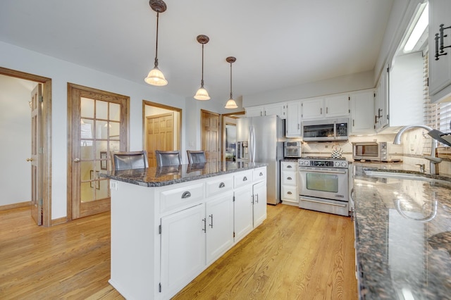 2624 Haddassah Dr, Naperville, IL 60565 - kitchen featuring white cabinetry, a kitchen island, dark stone counters, stainless steel appliances, and a sink