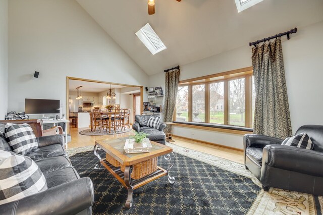 2624 Haddassah Dr, Naperville, IL 60565 - living area with a skylight, wood finished floors, high vaulted ceiling, and ceiling fan