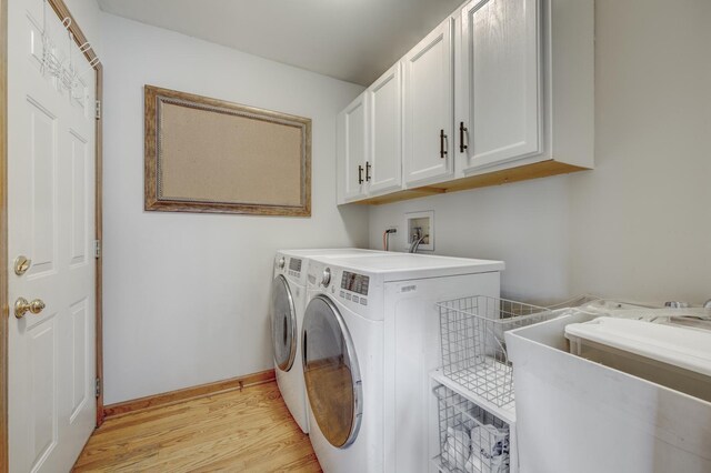 2624 Haddassah Dr, Naperville, IL 60565 - washroom featuring baseboards, light wood-style flooring, independent washer and dryer, cabinet space, and a sink