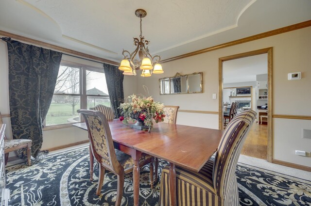 2624 Haddassah Dr, Naperville, IL 60565 - dining space featuring ornamental molding, baseboards, a tray ceiling, and a notable chandelier